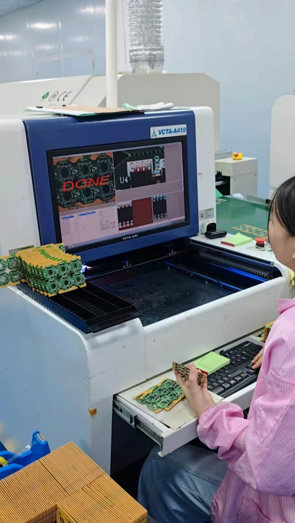 AOI operator inspecting assembled circuit boards